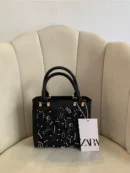 حقيبة زارا دانتيل أسود بفصوص بيضاء